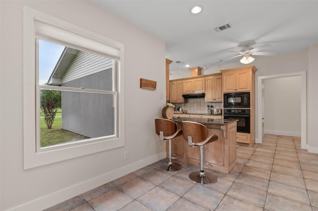 kitchen featuring light tile patterned flooring, baseboards, backsplash, visible vents, and black appliances