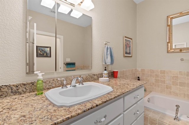 bathroom with a skylight, a bath, and vanity