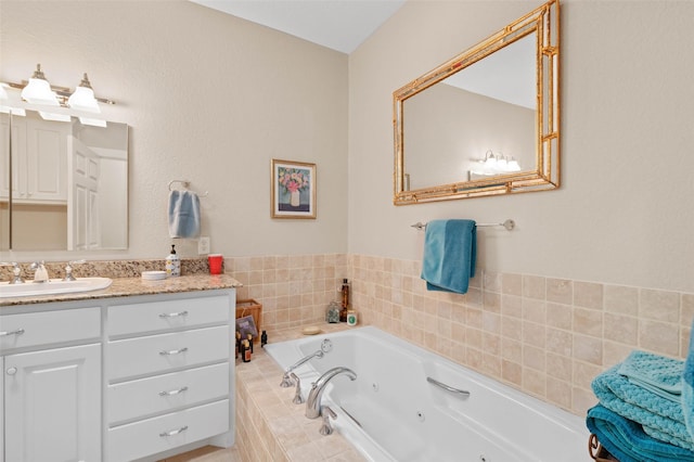bathroom with a whirlpool tub and vanity
