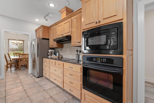 kitchen with under cabinet range hood, light brown cabinetry, and black appliances