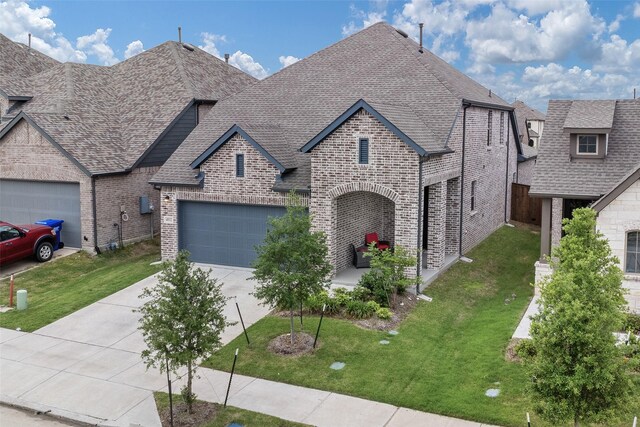 4012 Anglers Way, Royse City, TX 75189 - french country inspired facade with brick siding, a front yard, and concrete driveway