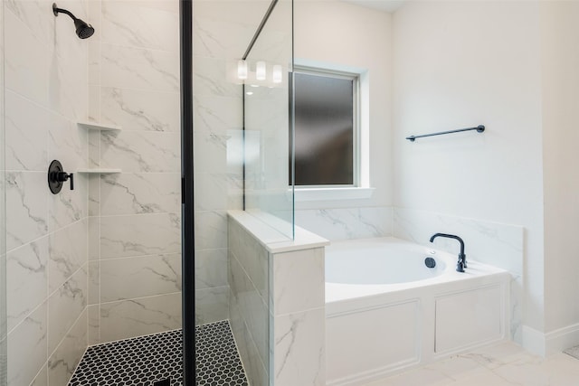 full bath featuring marble finish floor, a bath, and a stall shower