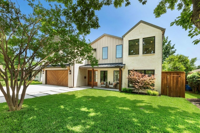 3920 Davila Dr, Dallas, TX 75220 - view of front of home featuring concrete driveway, brick siding, a standing seam roof, a front lawn, and board and batten siding