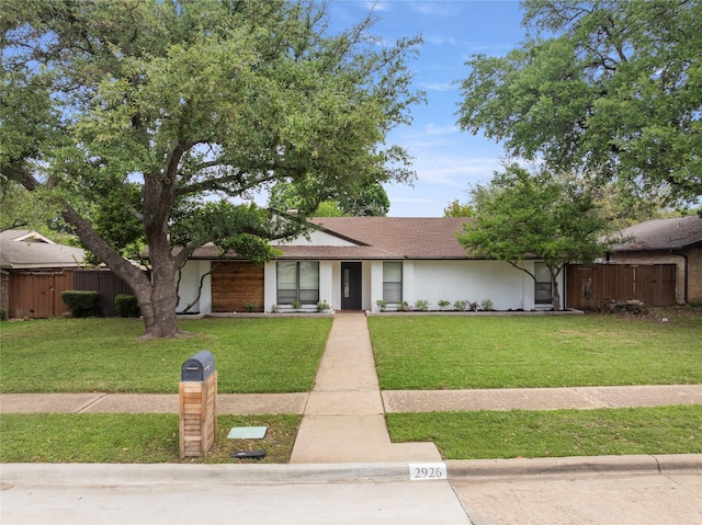 2926 Forest Hills Ln, Richardson, TX 75080 - ranch-style house with fence, roof with shingles, and a front lawn