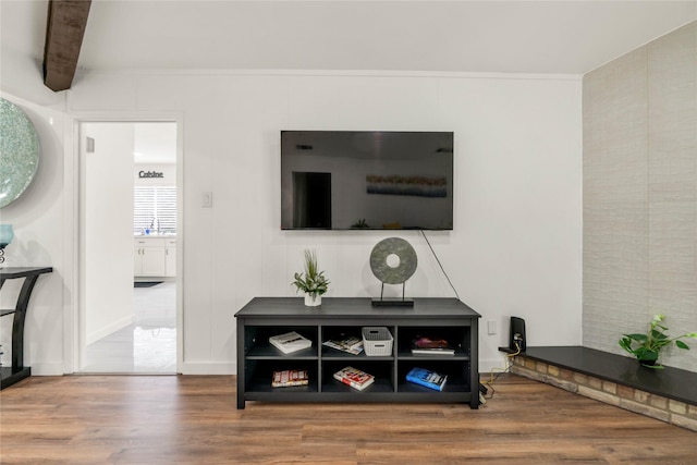 interior space featuring beamed ceiling and wood finished floors