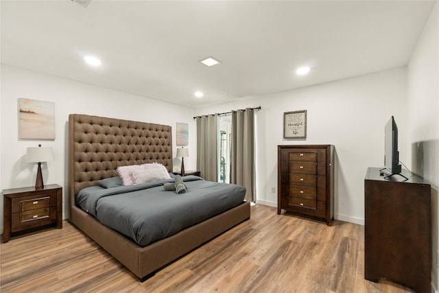 bedroom with recessed lighting, light wood-style flooring, and baseboards