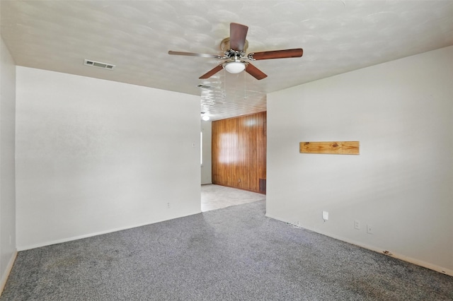 unfurnished room featuring visible vents, a ceiling fan, and light colored carpet