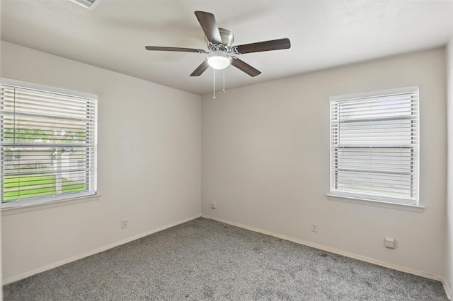 unfurnished room featuring carpet floors, a ceiling fan, and baseboards