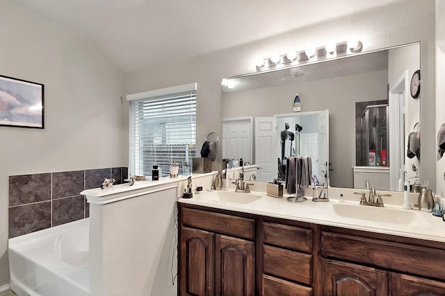 11800 Bexley Dr, Burleson, TX 76028 - bathroom with lofted ceiling, double vanity, a garden tub, and a stall shower