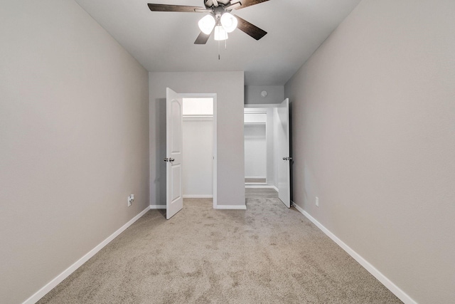 unfurnished bedroom with carpet floors, a ceiling fan, and baseboards