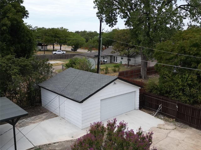 detached garage featuring fence