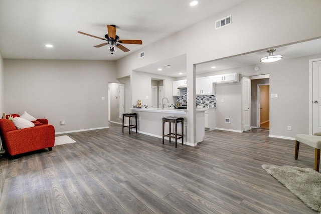 living area with recessed lighting, a ceiling fan, dark wood-style floors, and visible vents