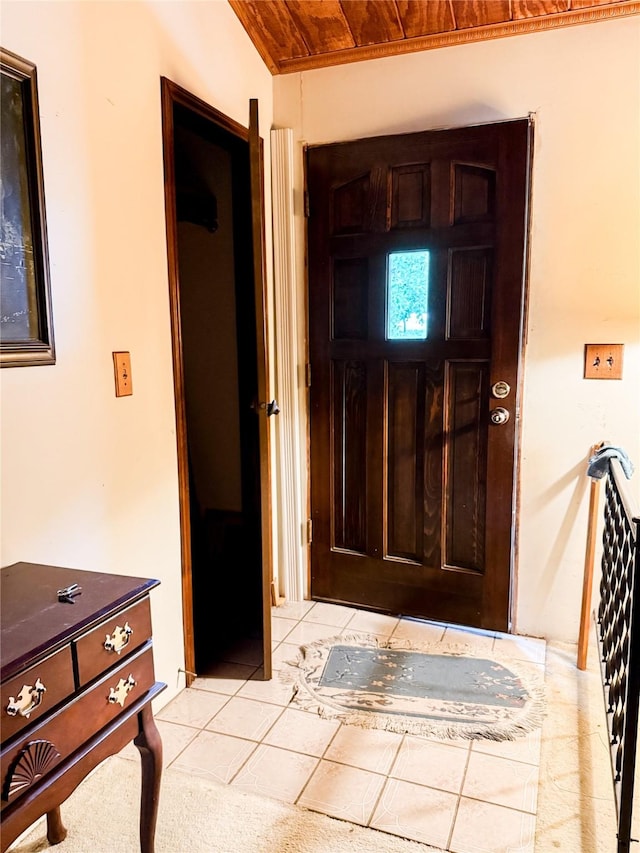 foyer with light tile patterned floors and wood ceiling