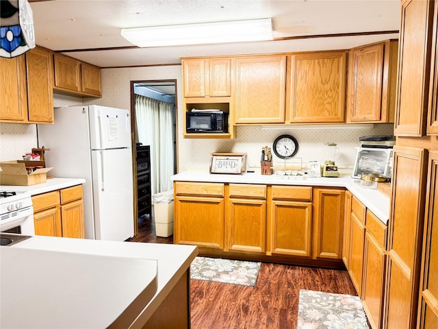 kitchen with dark wood-type flooring, light countertops, white range with gas stovetop, and black microwave