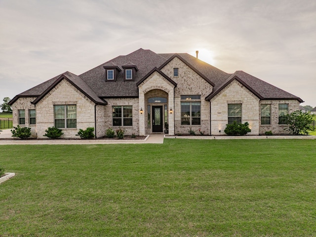 426 Norbury Dr, Rockwall, TX 75032 - french country inspired facade featuring brick siding, a shingled roof, a front lawn, and stone siding