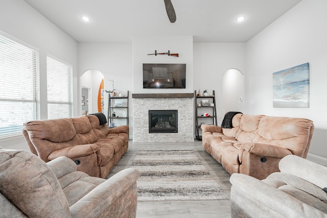 426 Norbury Dr, Rockwall, TX 75032 - living room featuring arched walkways, a stone fireplace, recessed lighting, and plenty of natural light