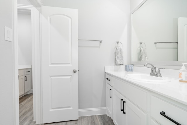 426 Norbury Dr, Rockwall, TX 75032 - bathroom with vanity, baseboards, and wood finished floors