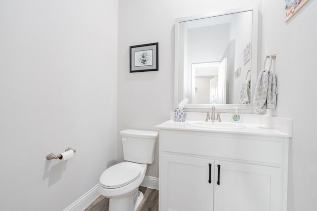 426 Norbury Dr, Rockwall, TX 75032 - bathroom featuring vanity, baseboards, wood finished floors, and toilet