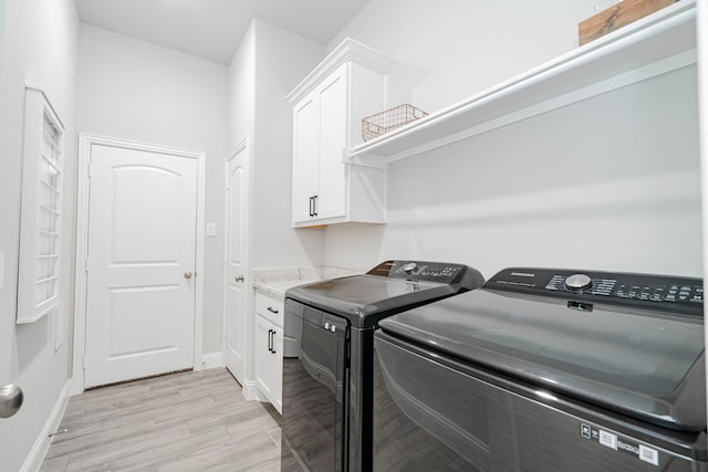 426 Norbury Dr, Rockwall, TX 75032 - laundry room featuring light wood-type flooring, washer and clothes dryer, cabinet space, and baseboards