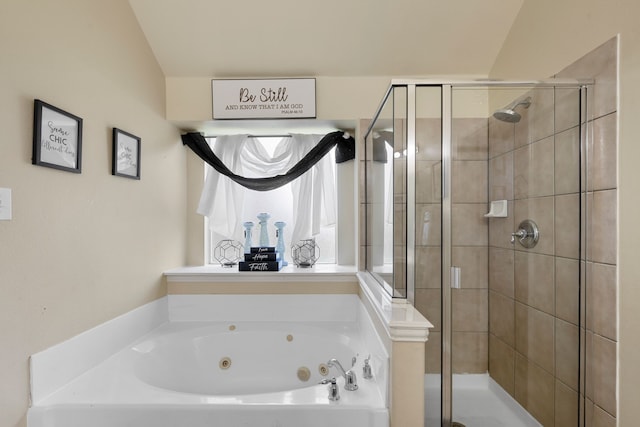 bathroom featuring a shower stall and a tub with jets