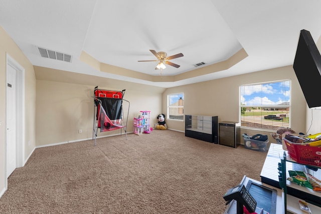 game room with visible vents, a raised ceiling, and ceiling fan