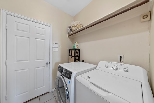 laundry area featuring light tile patterned floors, laundry area, and washing machine and dryer