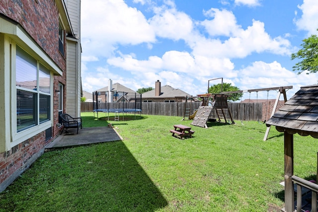 view of yard featuring a patio, a fenced backyard, a trampoline, and a playground