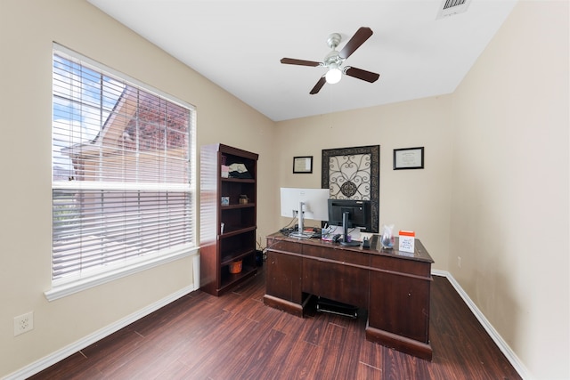 office space featuring ceiling fan, visible vents, plenty of natural light, and dark wood-type flooring