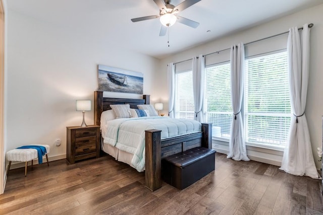 bedroom featuring baseboards, ceiling fan, and dark wood-style flooring