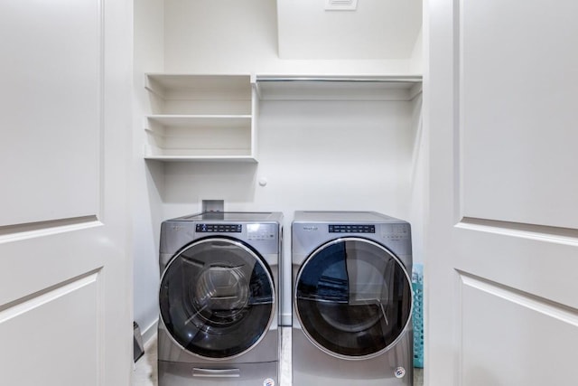 laundry room with laundry area and washer and clothes dryer
