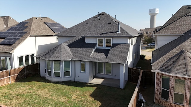 3720 Coldstream Dr, Irving, TX 75063 - rear view of house with a fenced backyard, roof with shingles, stucco siding, a patio area, and a lawn