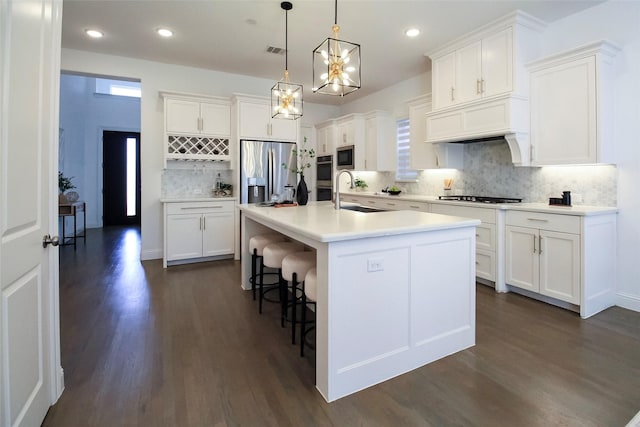 3720 Coldstream Dr, Irving, TX 75063 - kitchen with dark wood-style flooring, visible vents, tasteful backsplash, a sink, and stainless steel appliances