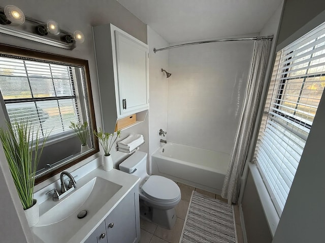 bathroom featuring vanity, a wealth of natural light, tile patterned flooring, and shower / tub combo