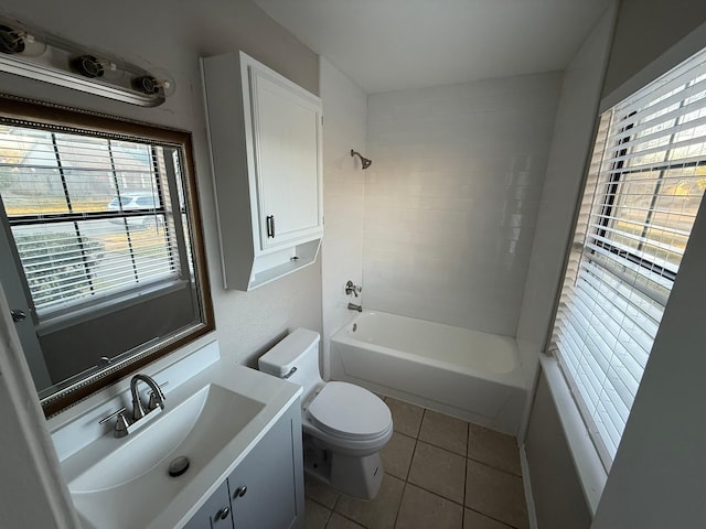 full bathroom featuring toilet, bathing tub / shower combination, a healthy amount of sunlight, and tile patterned flooring