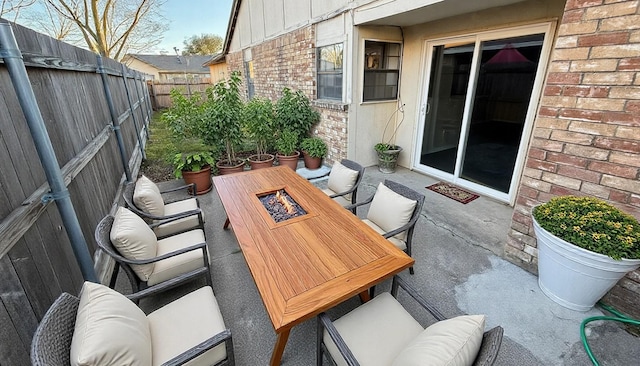 view of patio / terrace featuring a fenced backyard and a fire pit