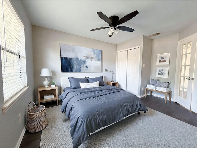 bedroom with visible vents, baseboards, ceiling fan, and a closet