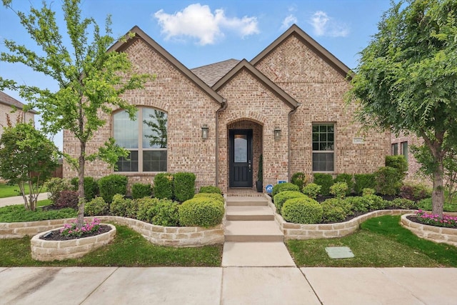 view of front of house featuring brick siding