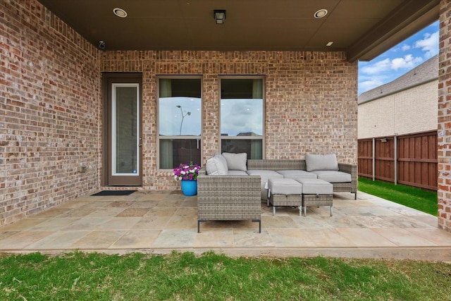 view of patio featuring an outdoor living space and fence