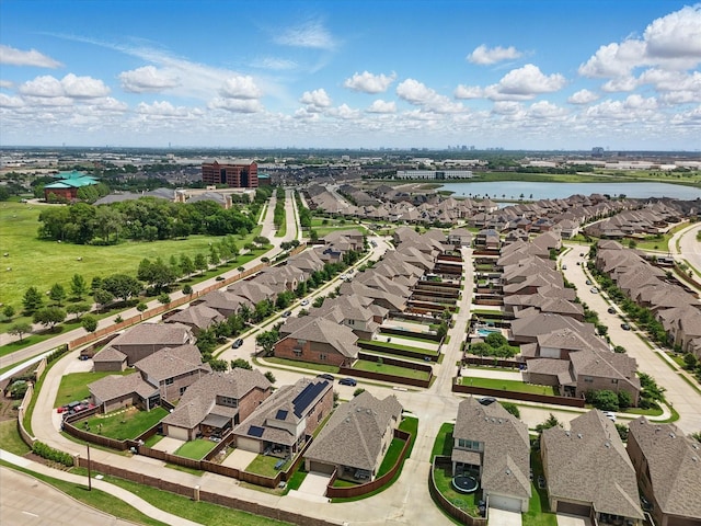 birds eye view of property with a residential view and a water view
