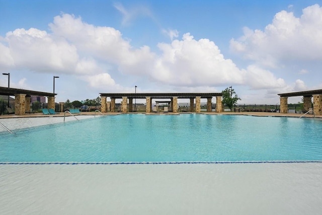community pool featuring fence