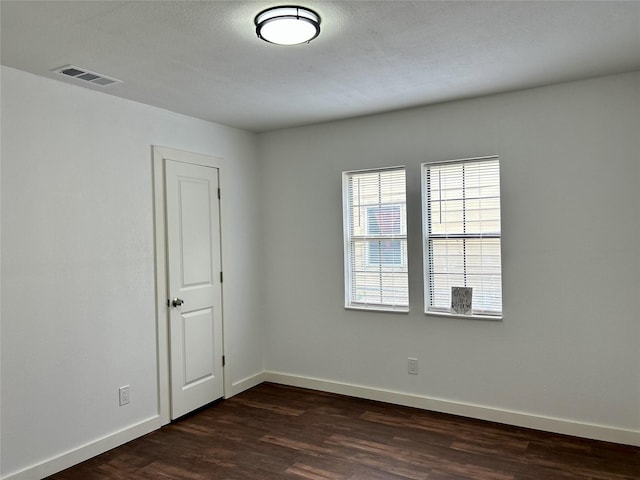 3408 Michigan Ave, Dallas, TX 75216 - empty room featuring baseboards, dark wood-style floors, and visible vents