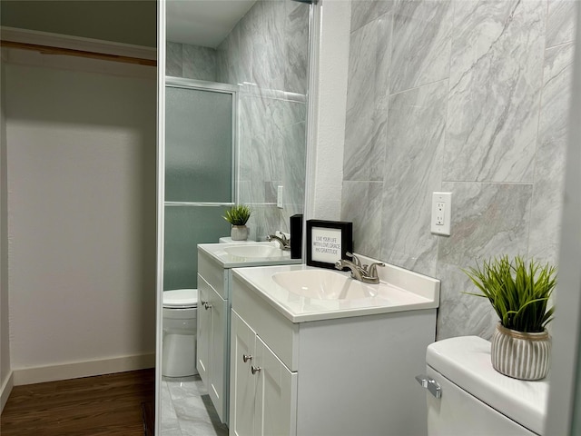 3408 Michigan Ave, Dallas, TX 75216 - full bath with vanity, toilet, baseboards, wood finished floors, and a shower with door