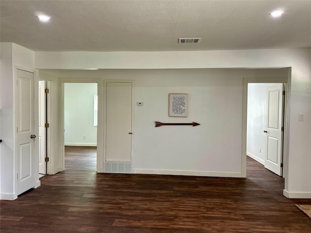 3408 Michigan Ave, Dallas, TX 75216 - unfurnished room featuring recessed lighting, baseboards, dark wood finished floors, and visible vents