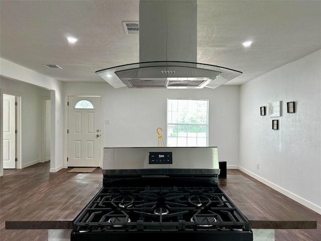 3408 Michigan Ave, Dallas, TX 75216 - kitchen with ventilation hood, stainless steel gas range oven, baseboards, wood finished floors, and visible vents