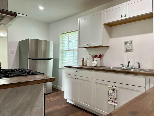 3408 Michigan Ave, Dallas, TX 75216 - kitchen featuring white cabinets, wooden counters, and a sink