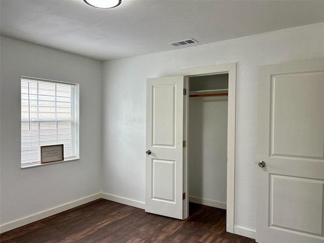 3408 Michigan Ave, Dallas, TX 75216 - unfurnished bedroom with visible vents, dark wood finished floors, baseboards, and a closet