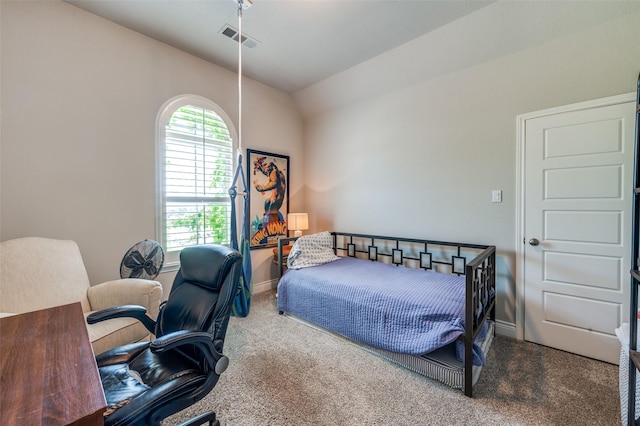 carpeted bedroom with baseboards, vaulted ceiling, and visible vents