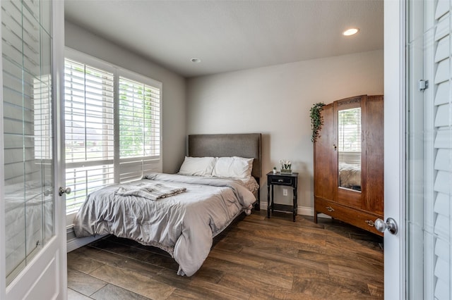 bedroom featuring dark wood-style flooring, baseboards, recessed lighting, and multiple windows