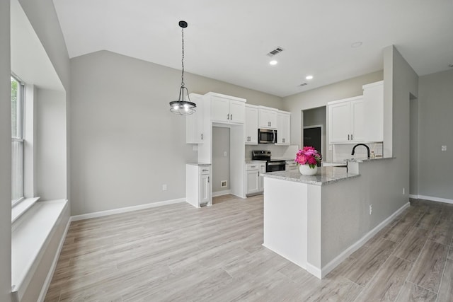 kitchen with visible vents, a peninsula, light stone countertops, white cabinetry, and stainless steel appliances