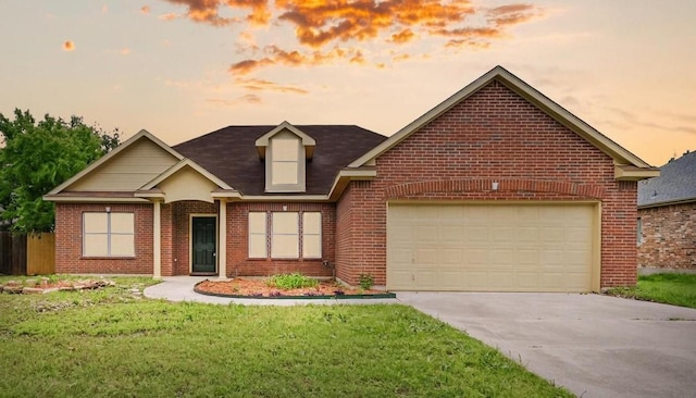 view of front of home with brick siding, an attached garage, a lawn, and concrete driveway